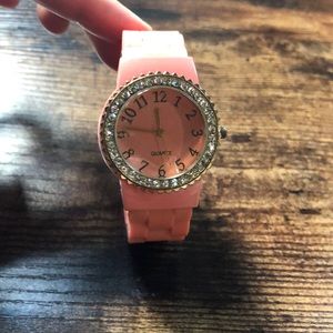 Peach watch with gold numbers, silver rhinestone details